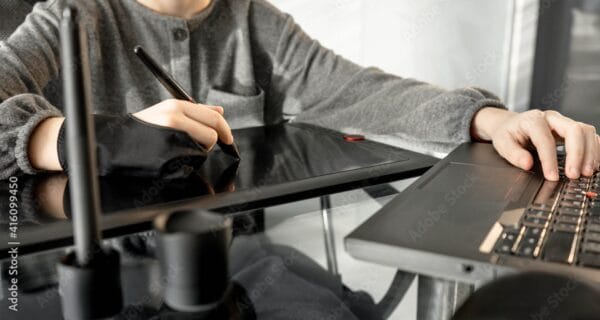 Young artist drawing on a digital tablet